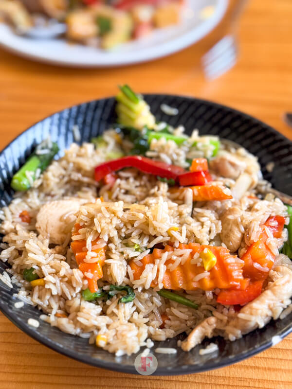 Thai fried rice with a lot of meat and vegetables throughout