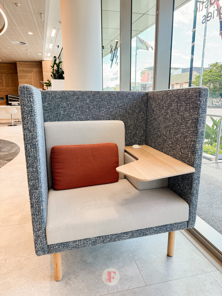 grey and white cubicle with orange pillow