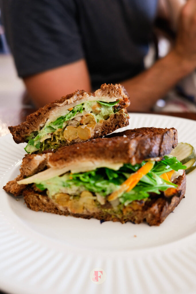 Sourdough sandwich with brocolli, chickpeas, green dressing, rocket and fennel