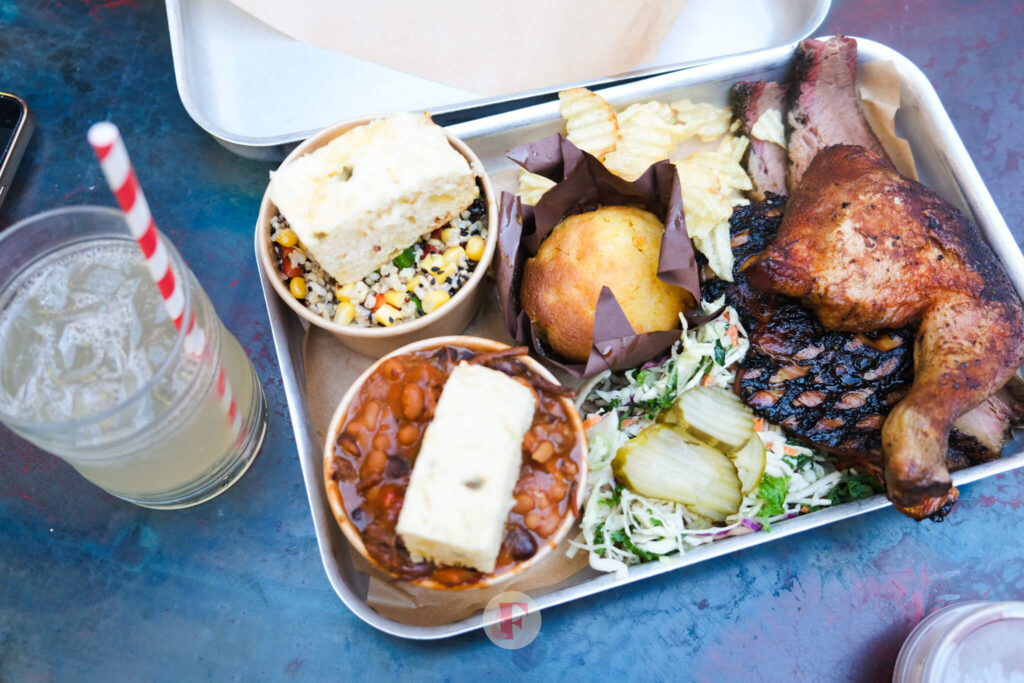 A huge platter of barbecued meats and Texan style side dishes