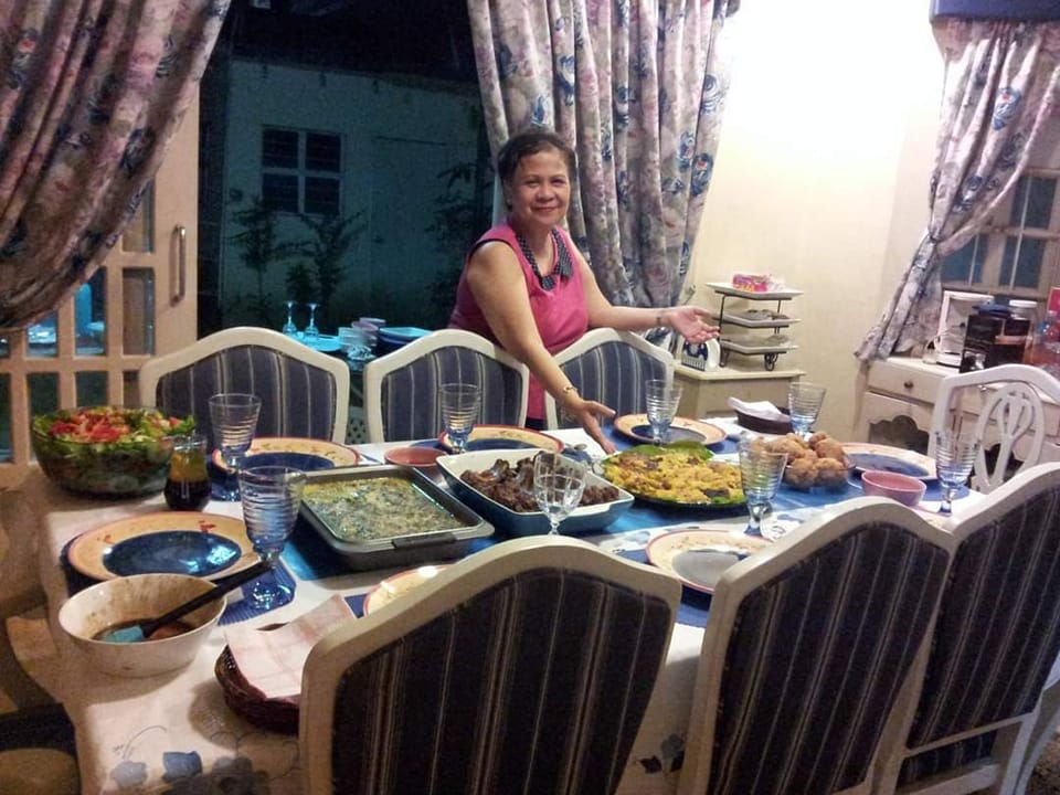My mom and her beautiful spread of food in our dining room table