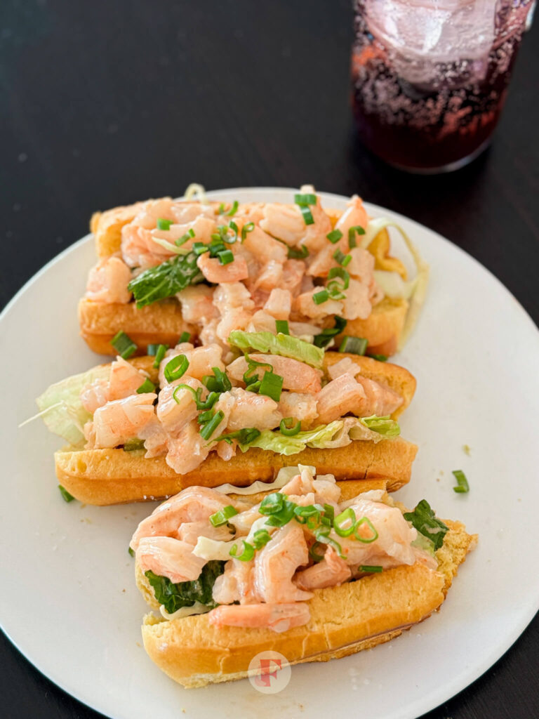 Toasted brioche rolls with generous servings of delicious prawn rolls with seafood sauce