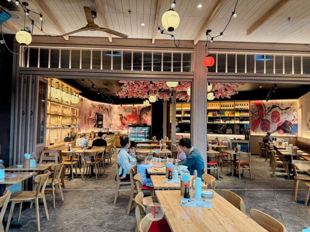 restaurant facade showing long tables and and open floor space