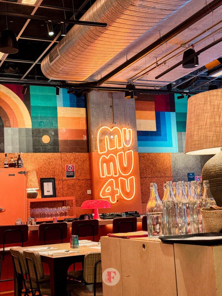 Interior of MuMu - glowing signage, orange accent walls