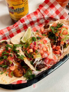 overhead shot of baja fish tacos and a lemon wedge