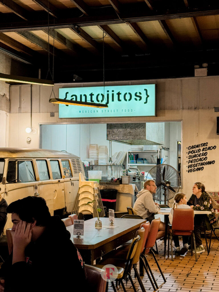 Antojitos signage with a vintage california surfing van